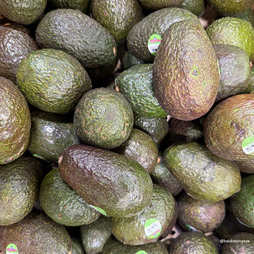 Pile of avocados in varying stages of ripeness