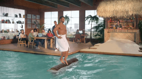 gif of man walking on log in a pool