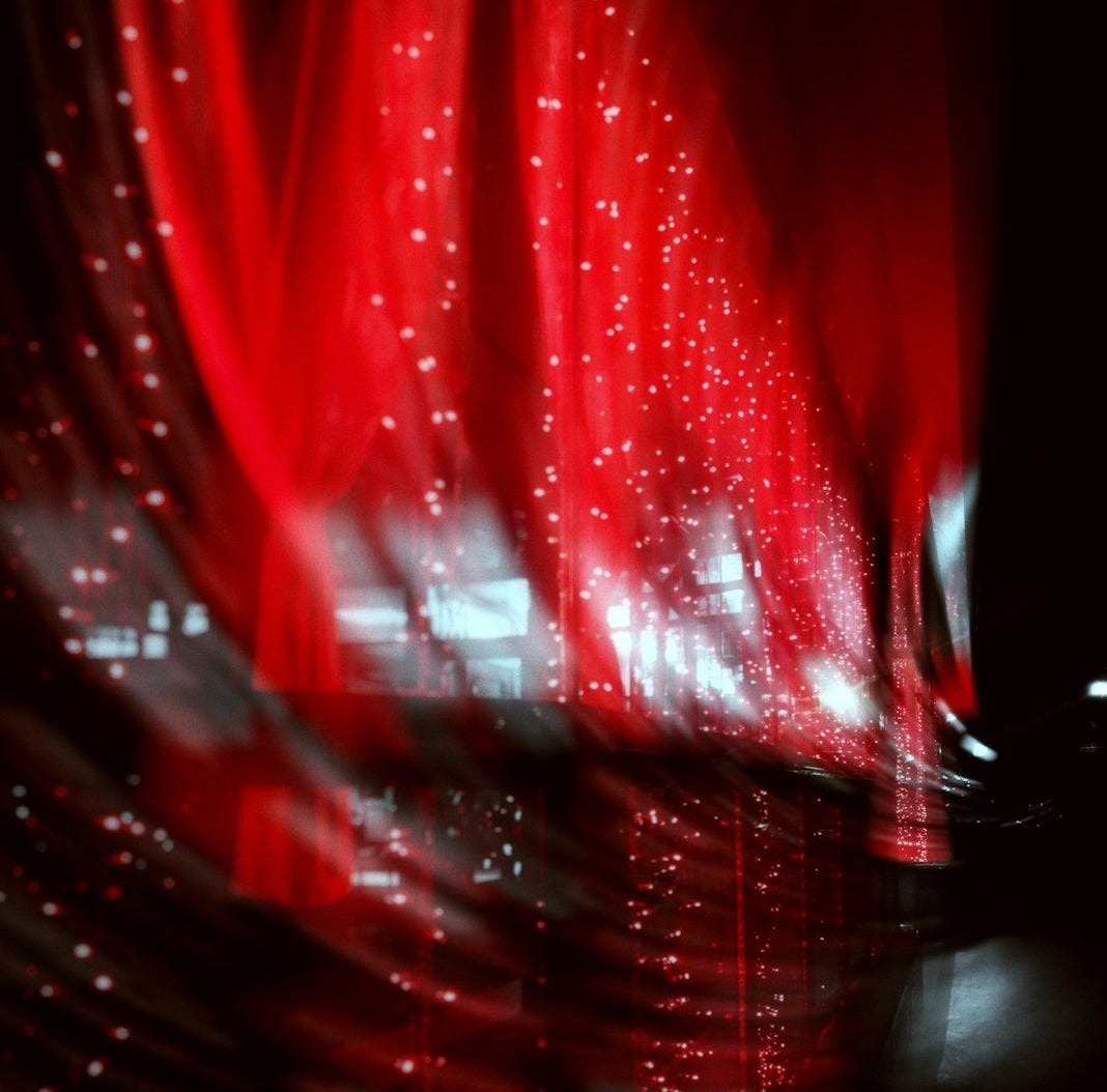 a blurry photo of a red curtain