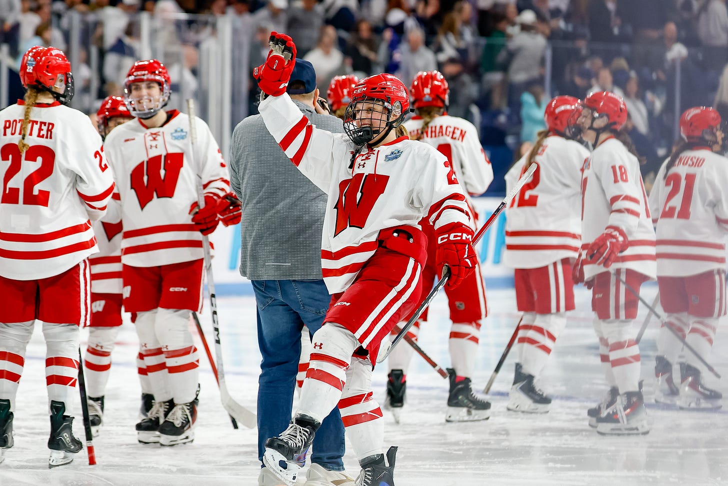 Wisconsin women's hockey winger Kirsten Simms lifts right right arms up while on the ice at the end of a game Wisconsin women's hockey winger Kirsten Simms lifts right right arms up while on the ice at the end of a game