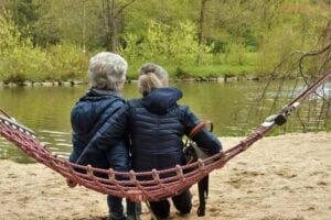 Women on a hammock looking at a pond