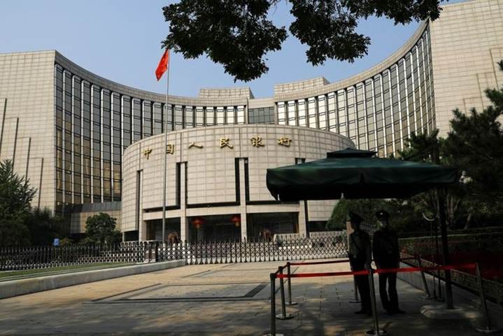 A large round building with a flag in front of it

Description automatically generated
