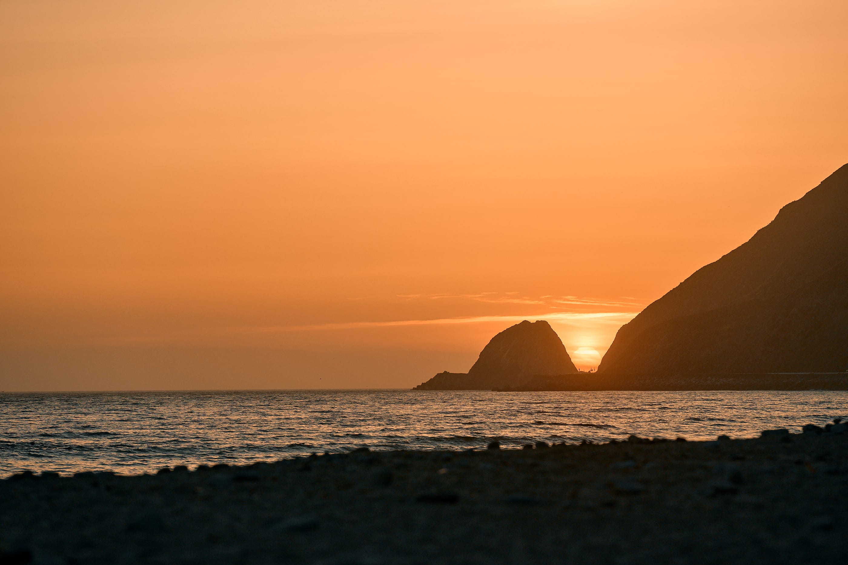 Sunset landscape photograph of Point Mugu Rock near Malibu California