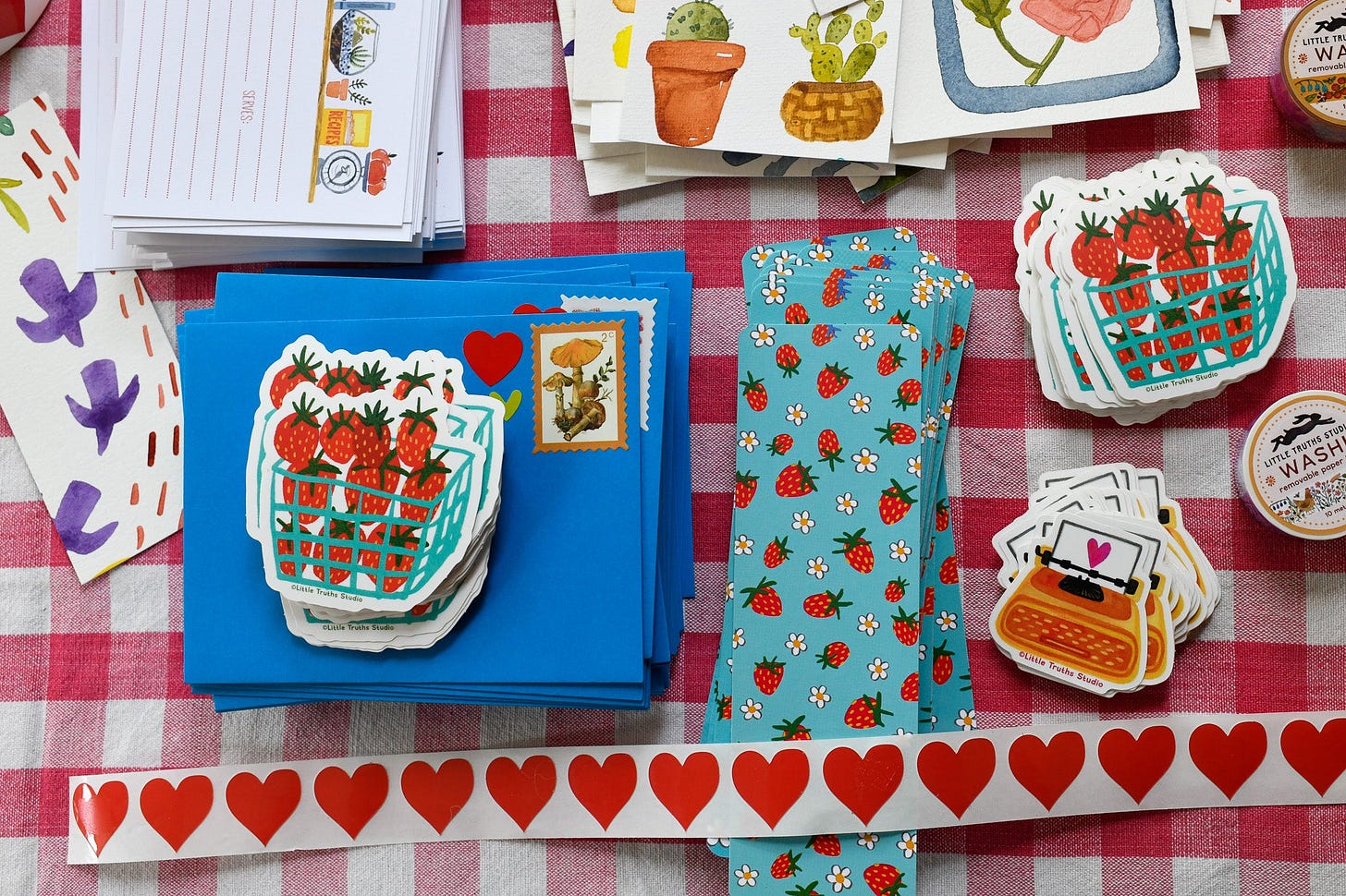 strawberry themed paper stationery on a table