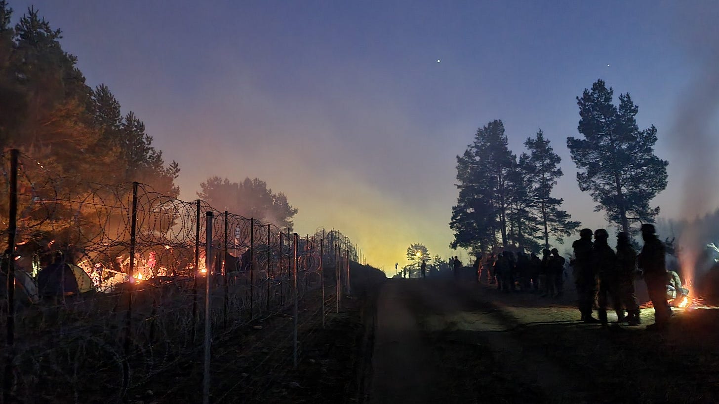 Police defence personnel (right) guarding the international border. Migrant camps can be seen on the other side of the fence in Belarus. (Image: Twitter/@PolskaPolicja) Police defence personnel (right) guarding the international border. Migrant camps can be seen on the other side of the fence in Belarus. (Image: Twitter/@PolskaPolicja)