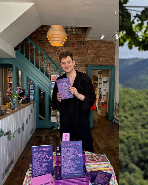 A visual journey through the launch of The Aftershock Review in May 2025. The bold purple magazine appears on indie bookshop shelves beside new releases, in readers’ hands across the UK, and onstage at Chorlton Arts Festival beneath stained glass windows and neon signage. Poets read from its pages in a church, a cappuccino rests beside a featured poem, and online praise rolls in from Poetry Book Society and The Bookseller. Bunting flutters outside festival venues, while mountains rise behind the magazine in the Alps — a testament to its reach, beauty, and community.