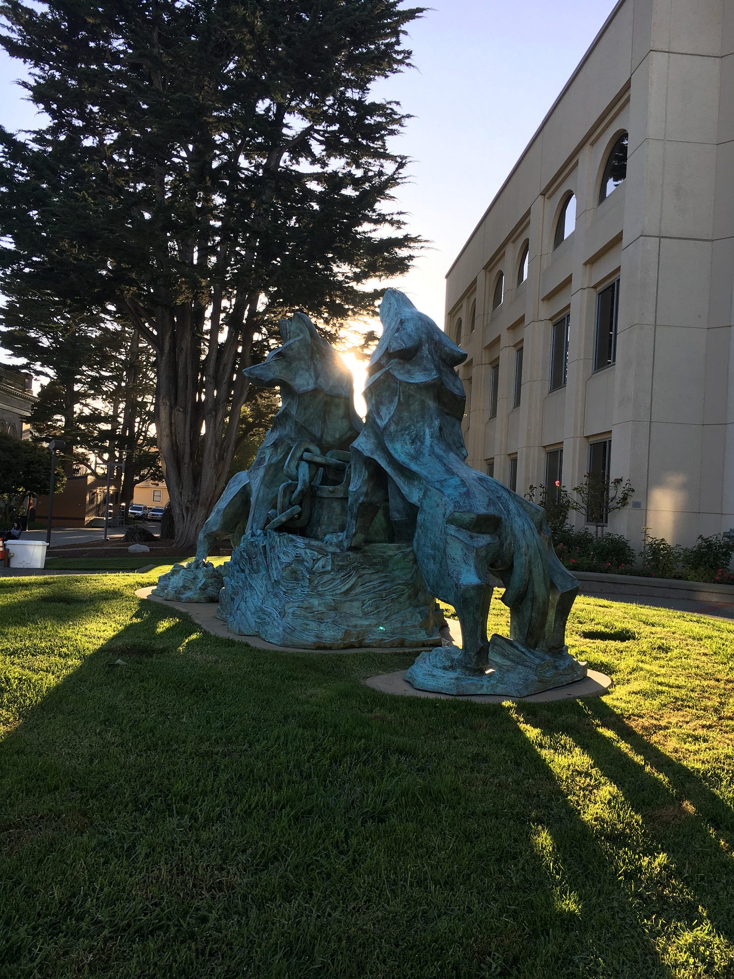 A statue of two wolves howling in front of the library at the University of San Francisco A statue of two wolves howling in front of the library at the University of San Francisco