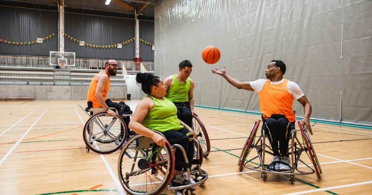 group of people playing wheelchair basketball on an indoor court
