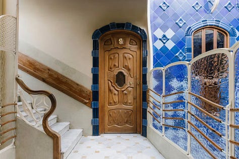 yellow dining room., blue kitchen, stairwell, two beds with canopy, living room and stairwell with tiles