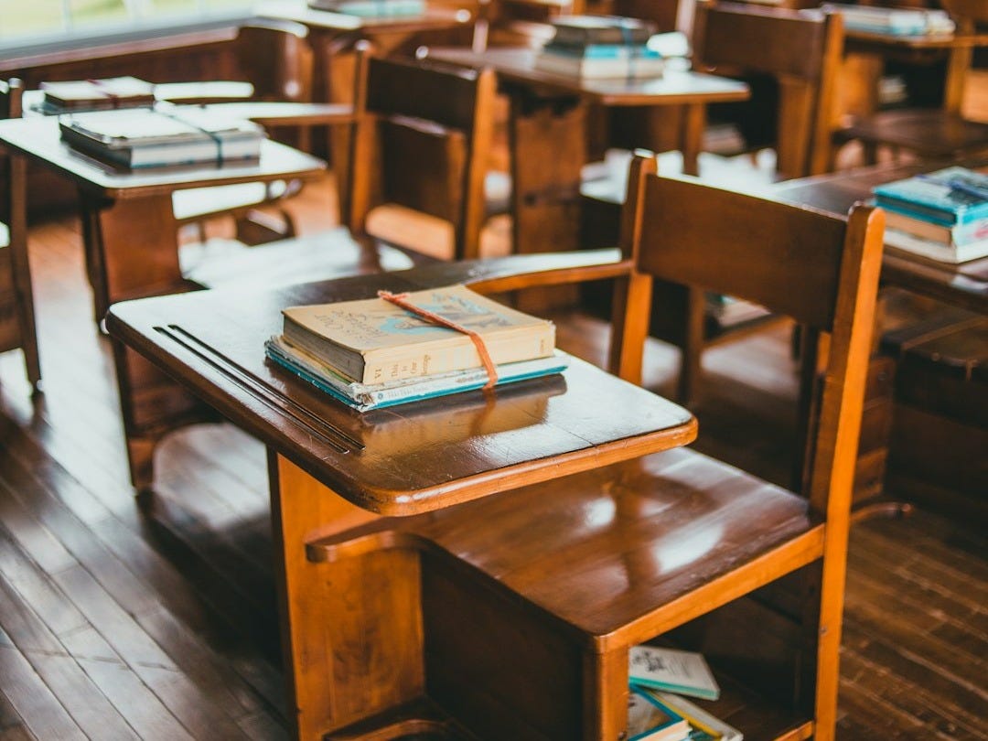 brown wooden table with books on top