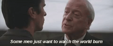 two men are looking at each other with the words " some men just want to watch the world burn " above them