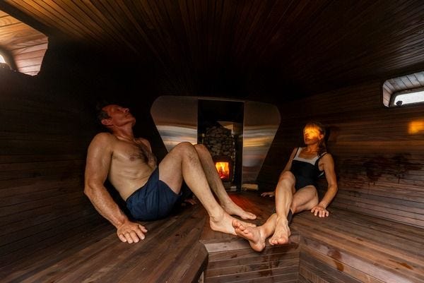 Guests relaxing in the sauna aboard Adventure Norrøna after a day of ski touring in Norway. Guests relaxing in the sauna aboard Adventure Norrøna after a day of ski touring in Norway.