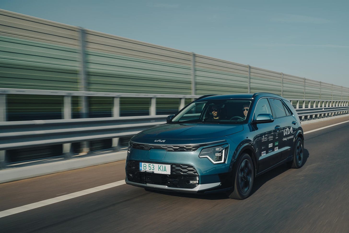 May be an image of car, road and text