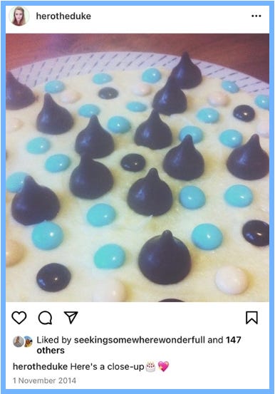 Hero posts a close-up image of the top of the cake. The brown pieces of chocolate are Kisses. Caption reads: Here's a close-up [birthday cake emoji, sparkle heart emoji]