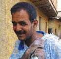 Left: A photo of an Iraqi man. Right: A photo of a destroyed house.