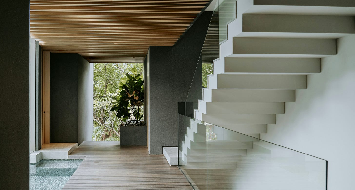 Modern architectural corridor leading toward a lush garden, where structured geometry gives way to an inviting landscape beyond. Modern architectural corridor leading toward a lush garden, where structured geometry gives way to an inviting landscape beyond.