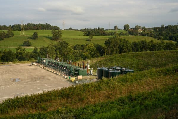 Natural gas equipment surrounded by fields with grass and trees. Natural gas equipment surrounded by fields with grass and trees.