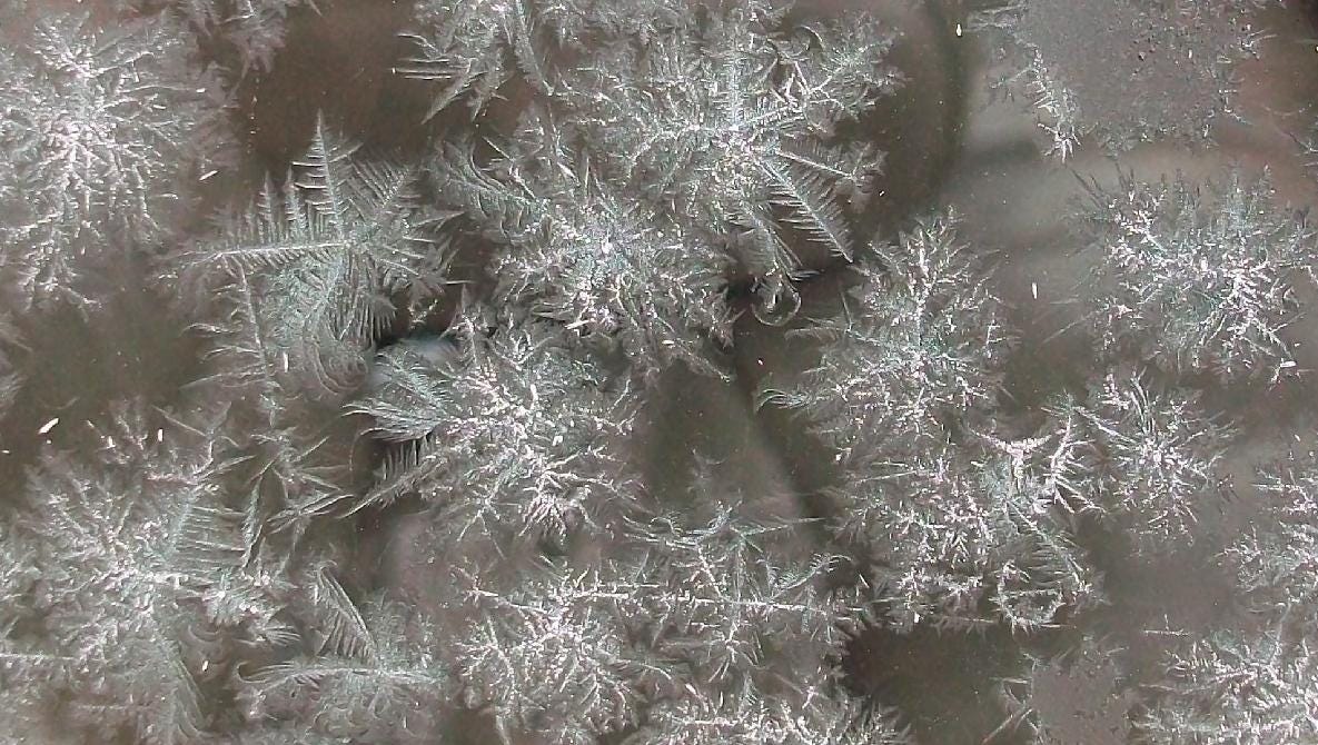 Ice crystals forming on a windshield