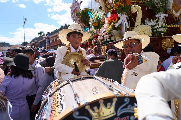 Four portraits taken during the Corpus Christi procession. The portraits show the diverse costumes of the procession attendees including two brightly colored rainbow outfits.