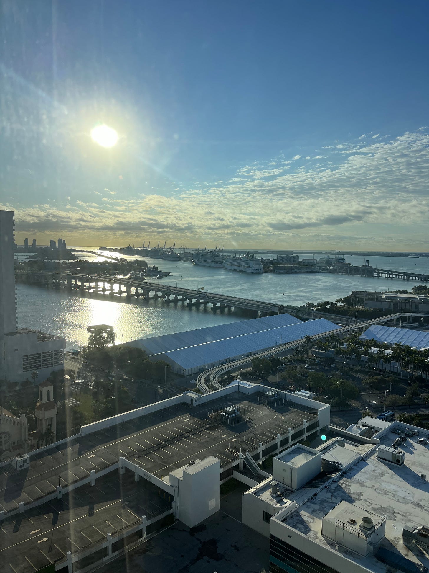 Photo out of hotel window showing view of Miami, including cruise ships lined up at the port Photo out of hotel window showing view of Miami, including cruise ships lined up at the port