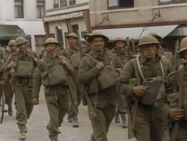 A group of soldiers walking down a street

AI-generated content may be incorrect.