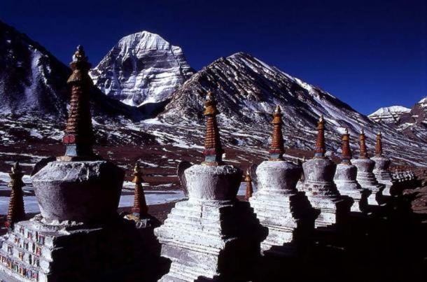 Stupas, with the north face of Mount Kailash in the background – both are symbols of axis mundi. Stupas, with the north face of Mount Kailash in the background – both are symbols of axis mundi.