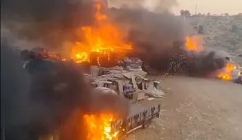 Homes going up in flames in the West Bank village of Deir Dibwan near Ramallah, Wednesday.