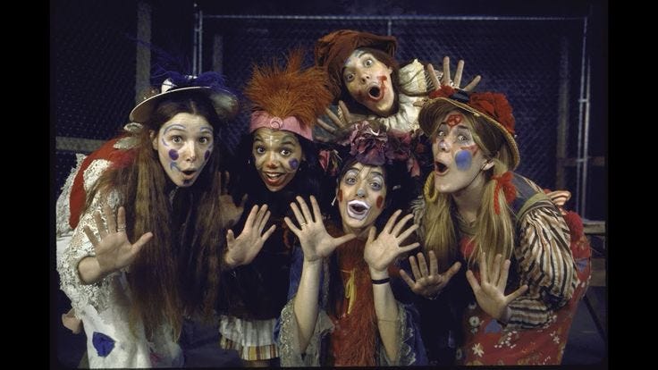 This may contain: five people dressed in costumes posing for the camera with their hands up and mouths open