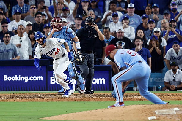 Andy Pages of the Los Angeles Dodgers hits a ground ball to Orion Kerkering of the Philadelphia Phillies during the 11th inning in game four of the...
