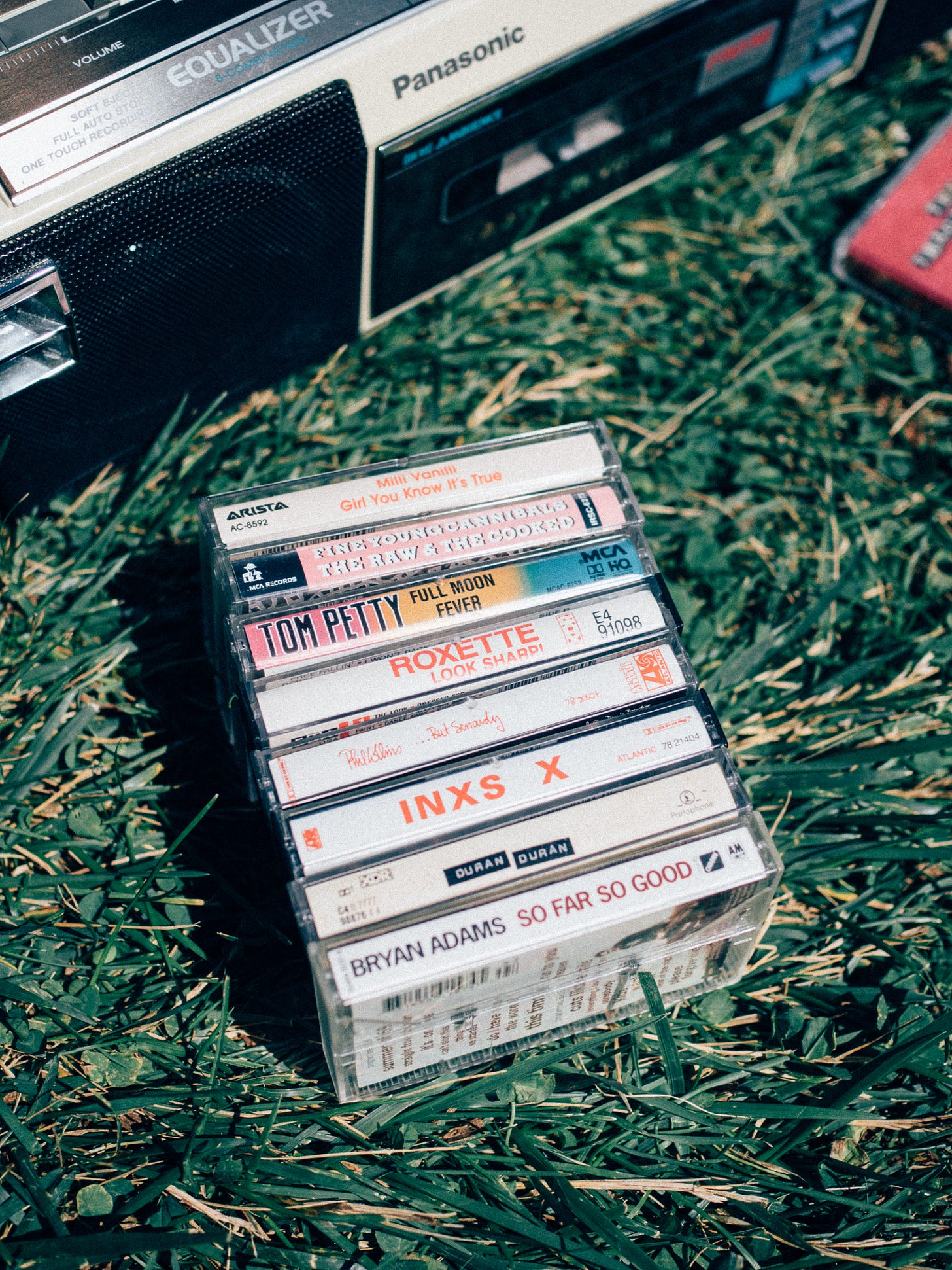 Photo of various 80s cassette tapes and boombox.