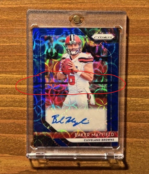 Example of front print line on 2018 Baker Mayfield Prizm Auto Rookie Card. Example of front print line on 2018 Baker Mayfield Prizm Auto Rookie Card.