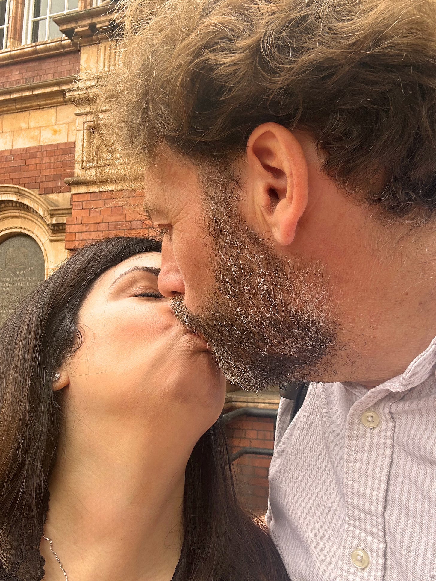 a mixed-race couple kissing