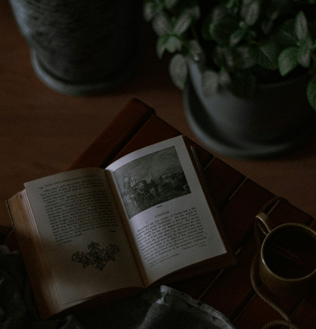 opened book on brown wooden table