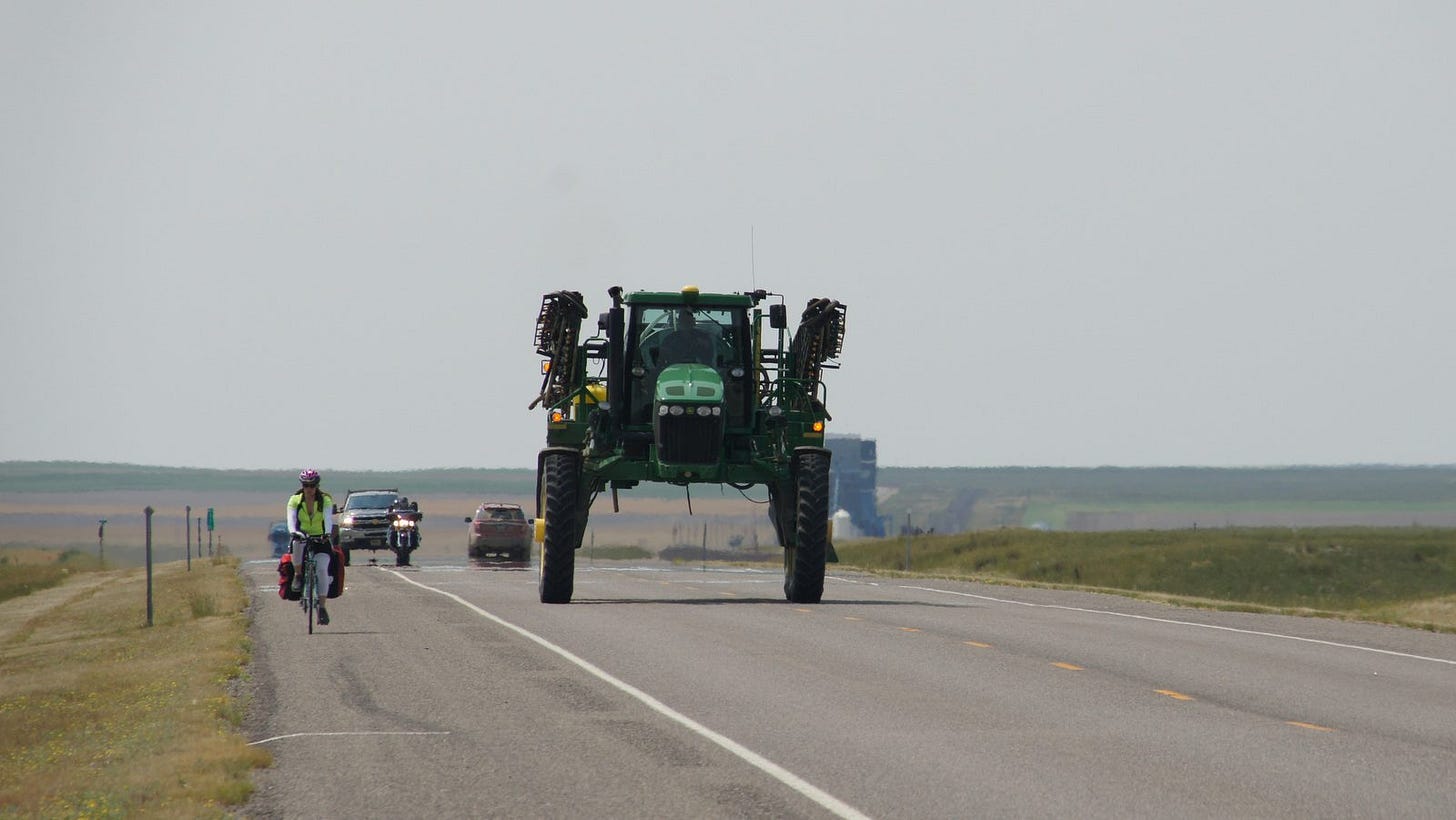 Chelsea and a giant piece of farm machinery share Highway 2 in northern Montana. Chelsea and a giant piece of farm machinery share Highway 2 in northern Montana.