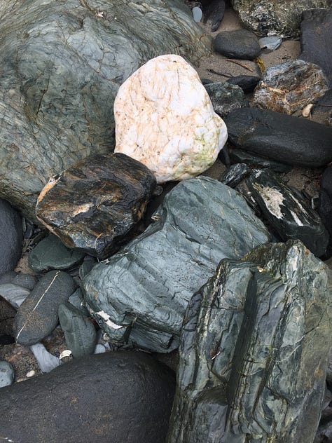 A lone rock in small cauldren, Åland; Lichen covered granite, close up on Åland; the water's edge all pebbles ans stones, Åland; A mountain of smooth stones, UK; wet, dark stones with one white quarz bit, Cornwall, UK; Piles of slate stone in St Nectan's Glen, Cornwall, UK