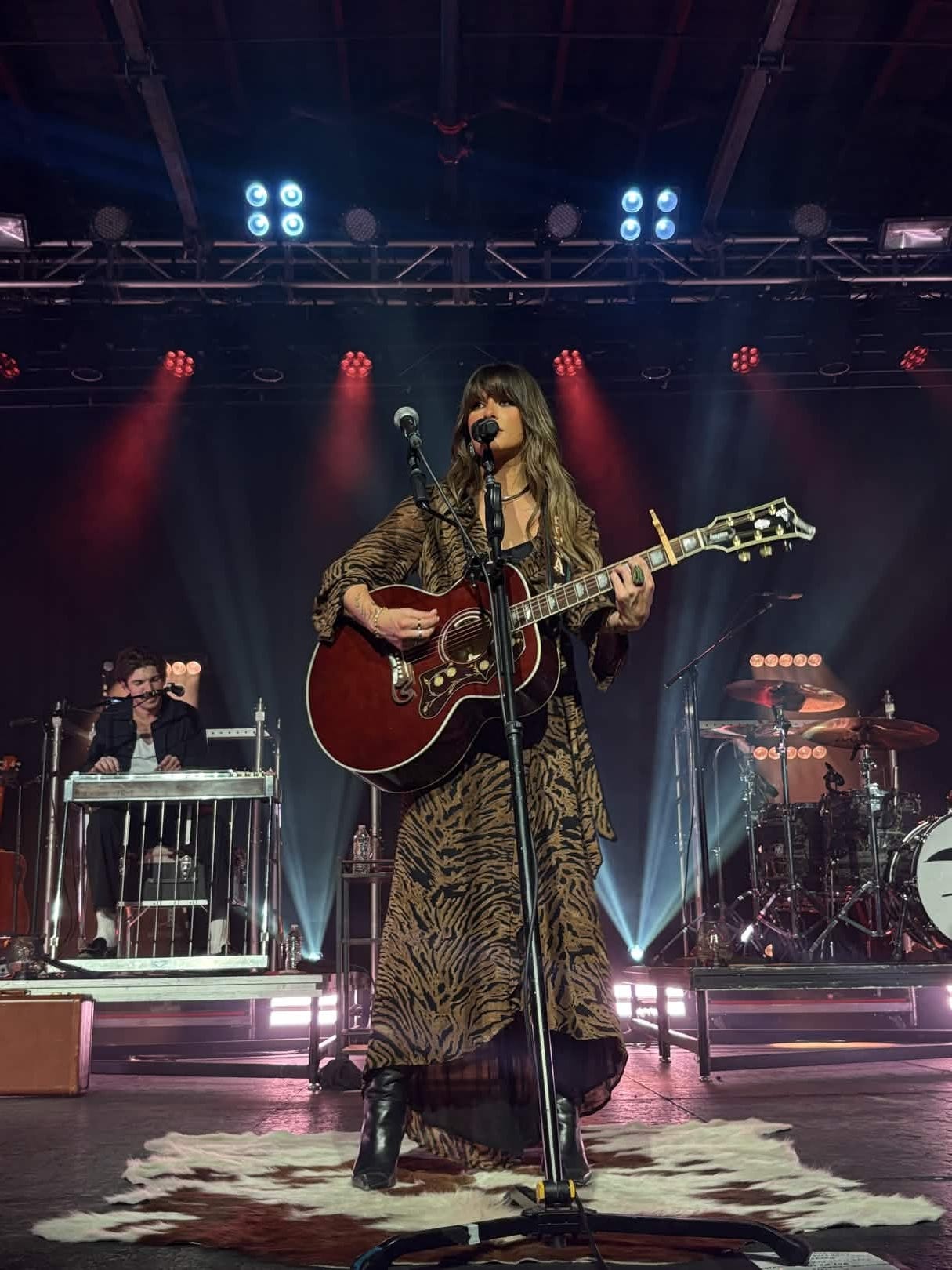 Country singer Ella Langley perfoms on stage holding a guitar