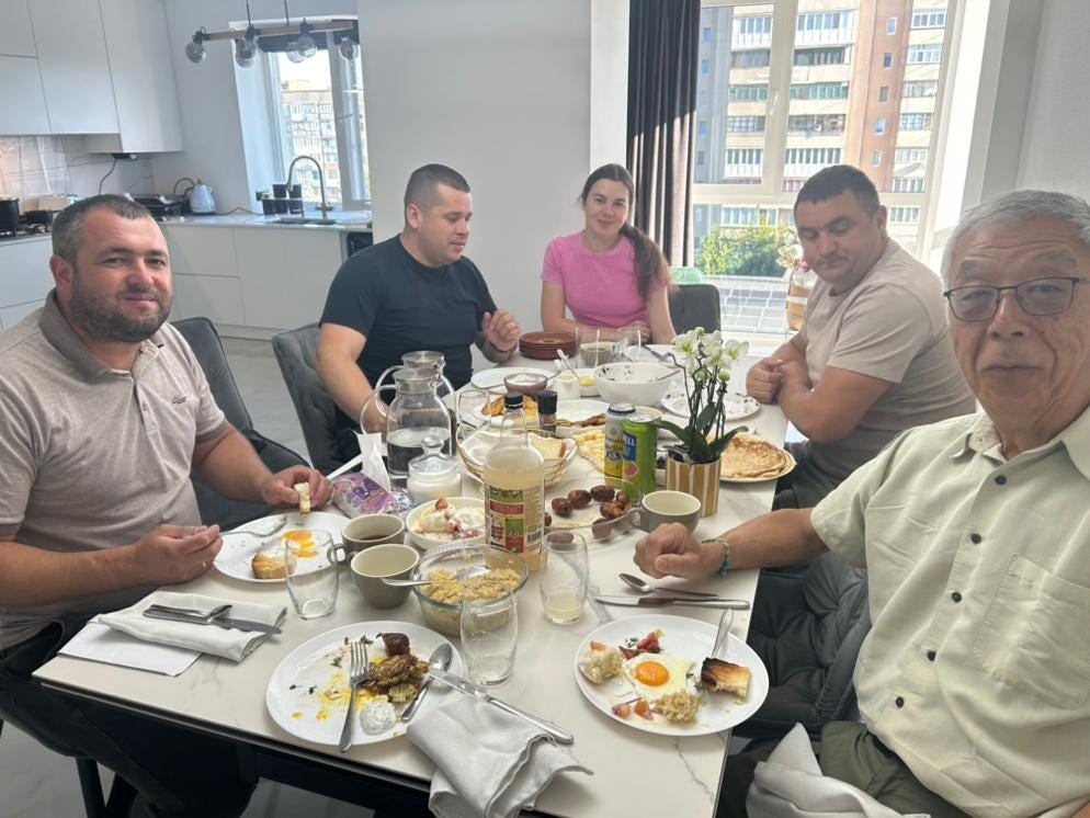 A group of people sitting around a table

AI-generated content may be incorrect.