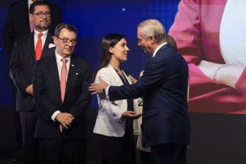 a man greets a woman on stage a man greets a woman on stage