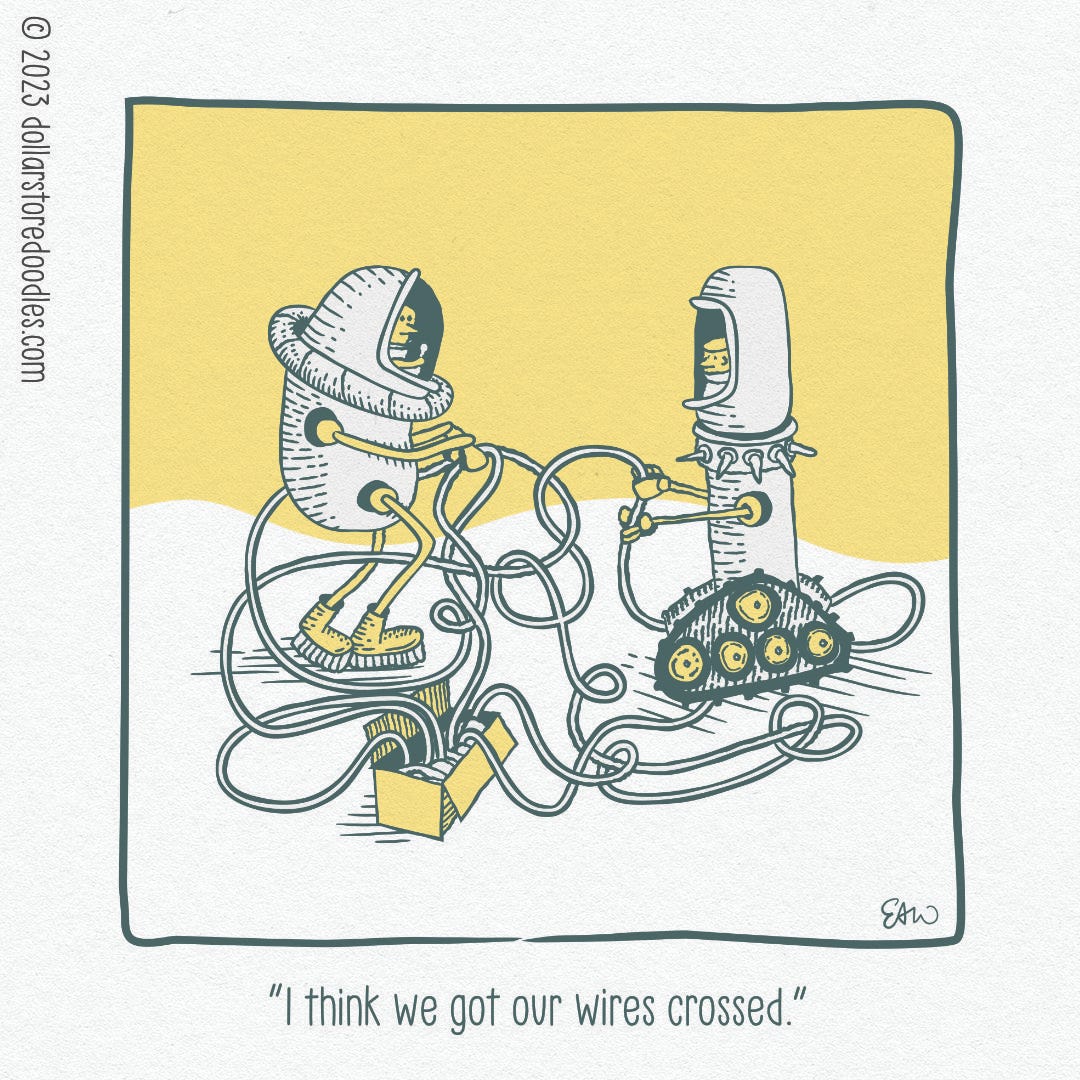 Single panel comic showing two human-like figures inside robotic space suits playing with an entangled box of wires. They are facing each other, each holding a loop of the tangled wire. The caption reads, "I think we got our wires crossed."