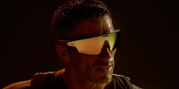 Closeup of a man wearing Oakley Meta glasses highlighting the Oakley Prizm lenses.