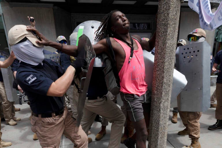 Charles Murrell III fends off a marcher from a group bearing insignias of the white supremacist group Patriot Front on Saturday, July 2, 2022, in Boston. (Credit: Michael Dwyer/ AP)