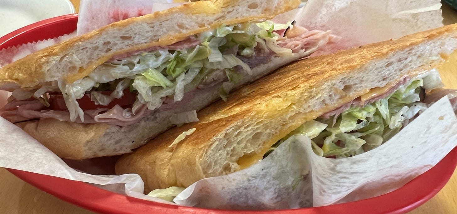 A close-up of the Cuban sandwich at the West Tampa Sandwich Shop, with an odd bright yellow line of cheese.
