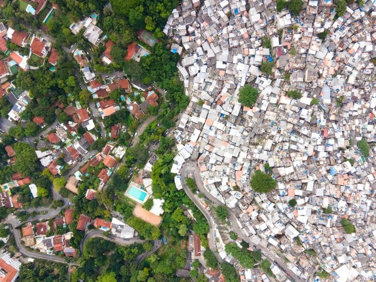 This may contain: an aerial view of a city with lots of houses and trees in the foreground