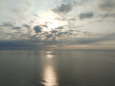 Three sunrise photographs from my solo trip to Cha-am, Thailand, showing calm ocean water, changing morning skies, and light reflecting across the sea.