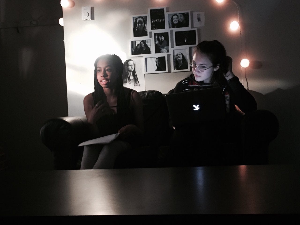 Mia Fowler (Dot) and CBG (Billie) get ready to film an episode of the web series. CBG is reading off a laptop and Mia is looking up from a paper script.