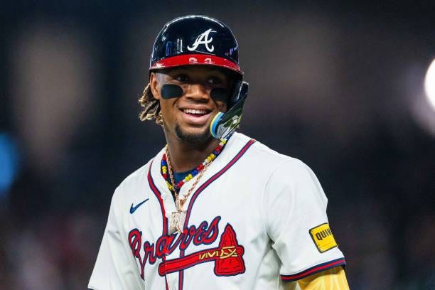 Ronald Acuña Jr. #13 of the Atlanta Braves smiles in the fifth inning against the Arizona Diamondbacks at Truist Park on April 6, 2024 in Atlanta,...