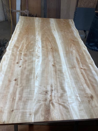 Soft Maple boards joined together to make a table top. A variety of drills, drivers, clamps, dead blow hammers, screws.