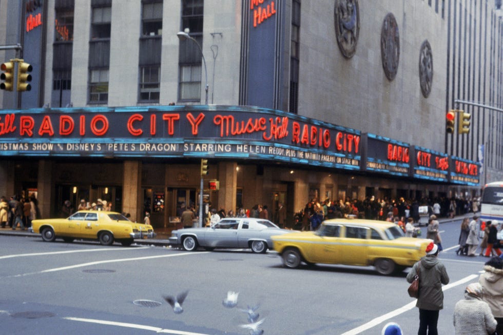 Iconic yellow cabs navigating a busy Manhattan street, quintessential 1970s New York transport. Iconic yellow cabs navigating a busy Manhattan street, quintessential 1970s New York transport.
