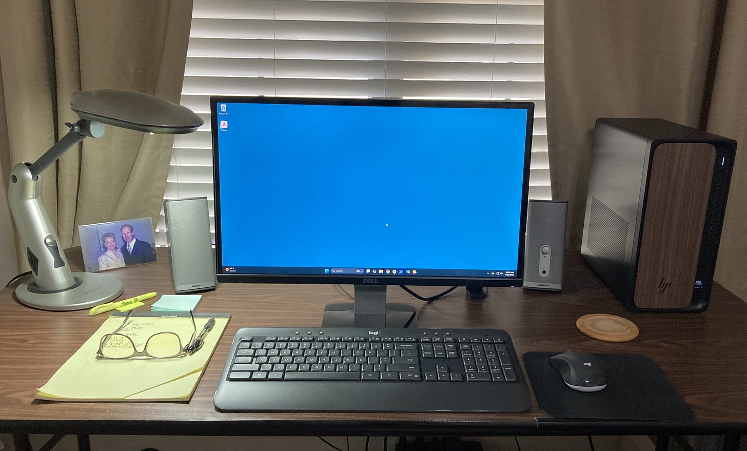 front view of my desk with desk lamp, speakers, monitor, keyboard, mouse, and HP Omnidesk pc