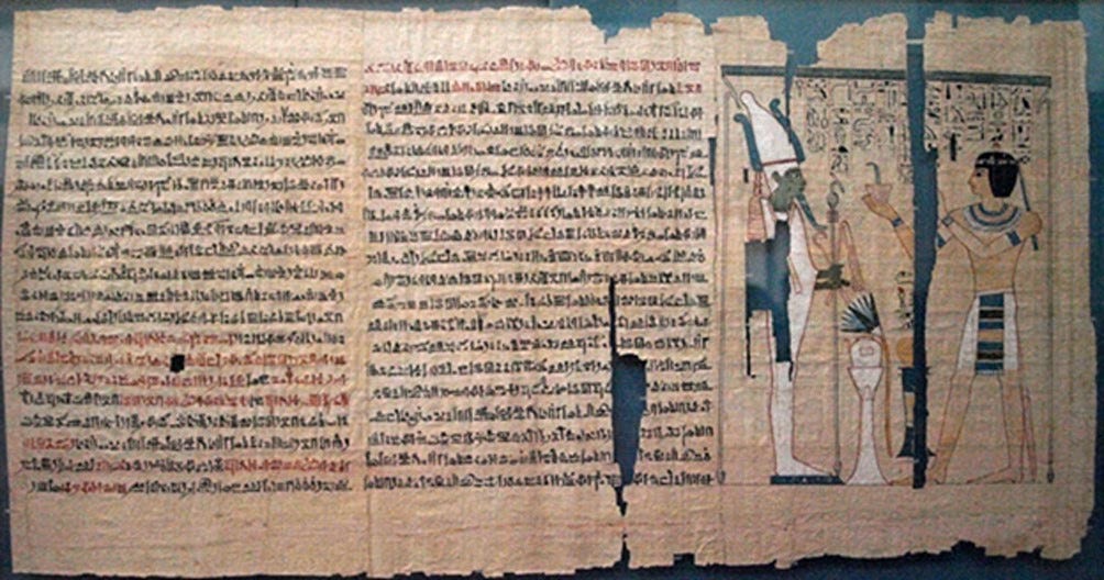 Part of the Book of the Dead of Pinedjem II. The text is hieratic, except for hieroglyphics in the vignette. The use of red pigment, and the joins between papyrus sheets, are also visible. Part of the Book of the Dead of Pinedjem II. The text is hieratic, except for hieroglyphics in the vignette. The use of red pigment, and the joins between papyrus sheets, are also visible.